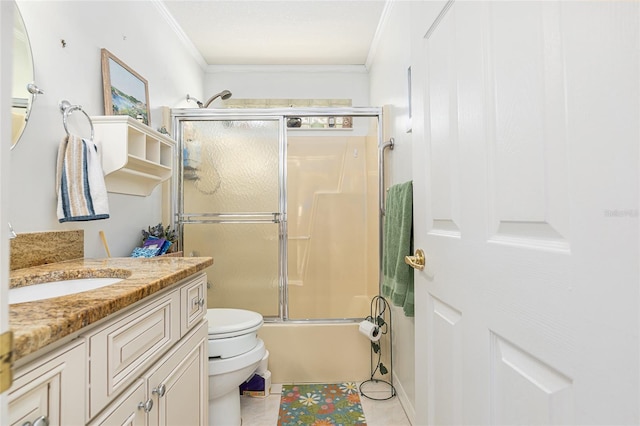 bathroom featuring shower / bath combination with glass door, crown molding, toilet, vanity, and tile patterned flooring