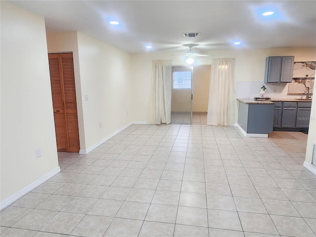 unfurnished living room with light tile patterned floors, baseboards, visible vents, and recessed lighting