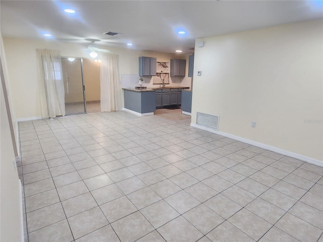 unfurnished living room with baseboards, visible vents, a ceiling fan, and recessed lighting