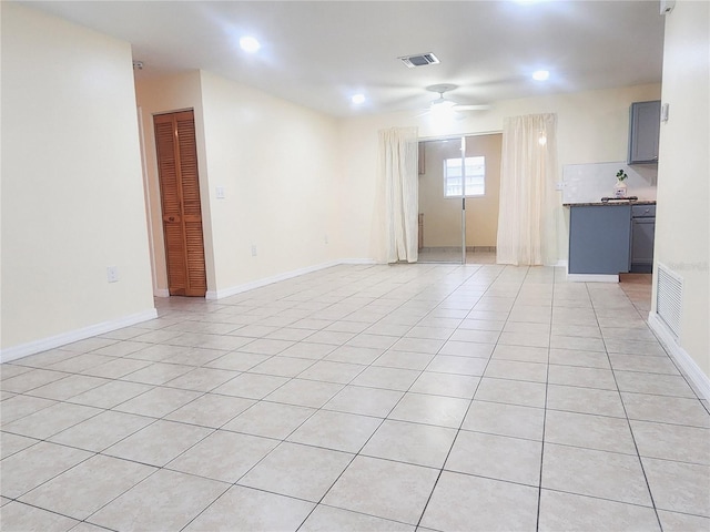 unfurnished room featuring visible vents, ceiling fan, baseboards, and light tile patterned flooring