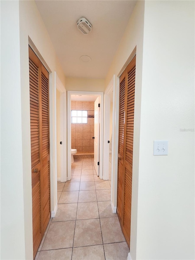 hall with light tile patterned flooring