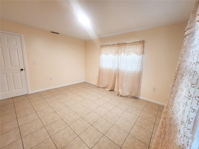 empty room featuring visible vents and baseboards