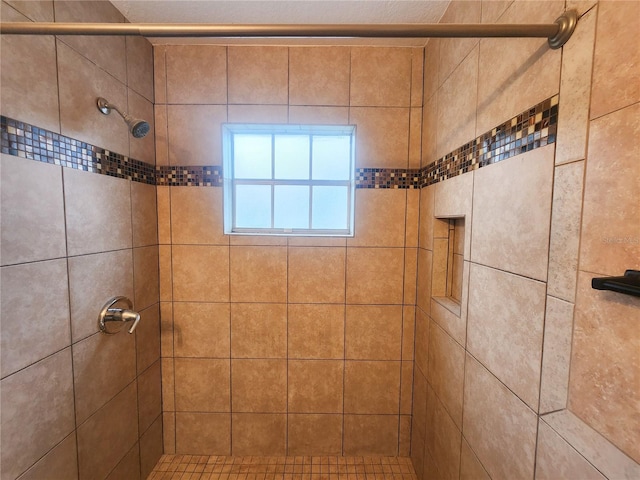 full bath with tiled shower