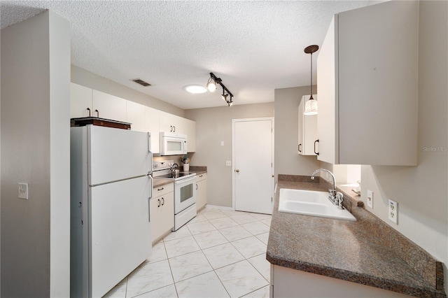 kitchen featuring white appliances, visible vents, white cabinets, a textured ceiling, and a sink