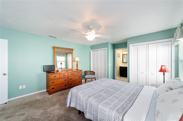 bedroom with carpet floors, multiple closets, visible vents, a ceiling fan, and baseboards