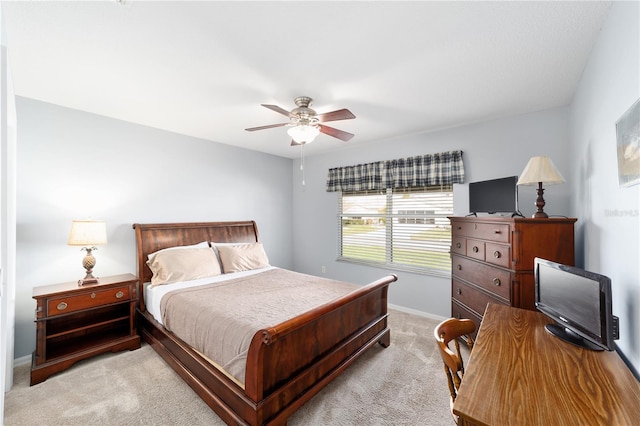 bedroom with light carpet, ceiling fan, and baseboards