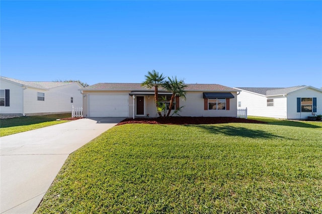 view of front of property with an attached garage, concrete driveway, and a front yard