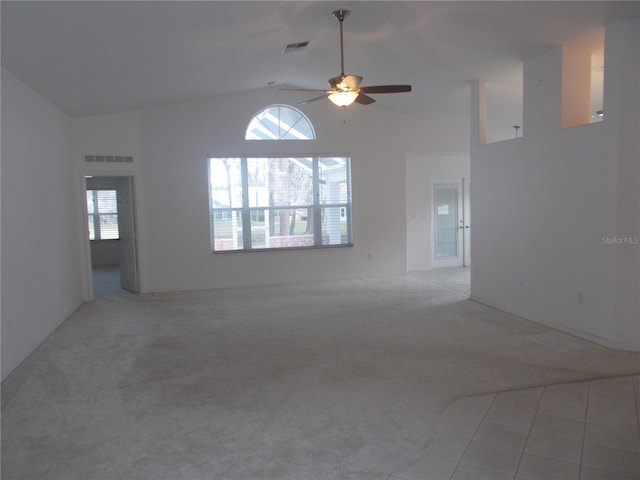 unfurnished living room featuring light carpet, high vaulted ceiling, ceiling fan, and visible vents