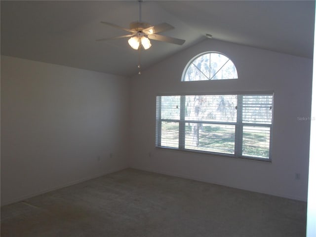 empty room with vaulted ceiling, carpet, and a ceiling fan