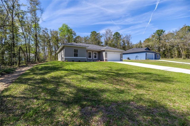 ranch-style home with a garage, driveway, a front lawn, and stucco siding