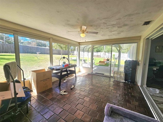 sunroom / solarium with visible vents and ceiling fan