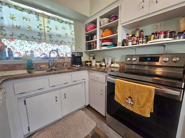 kitchen featuring wood finished floors, a sink, white cabinets, stainless steel electric range, and open shelves