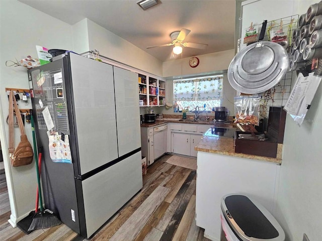 kitchen with wood finished floors, visible vents, white cabinetry, freestanding refrigerator, and dishwasher