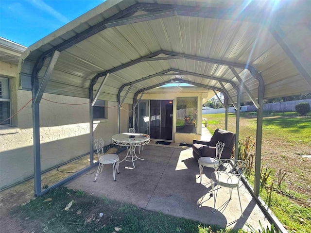 view of car parking featuring fence and a detached carport