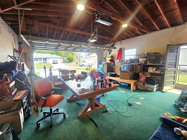 garage featuring concrete block wall and a garage door opener