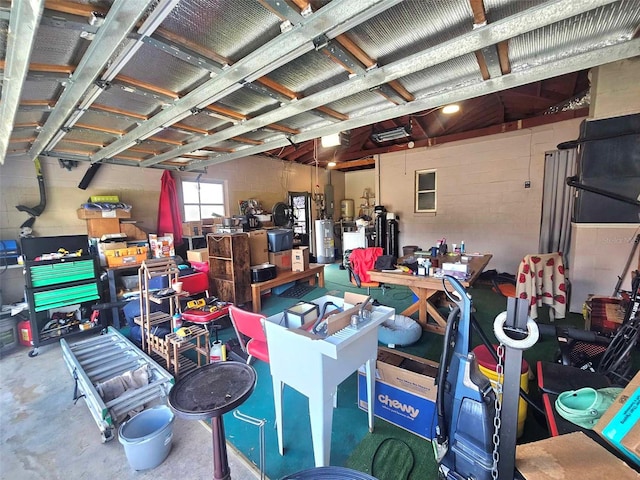 garage with concrete block wall and a workshop area