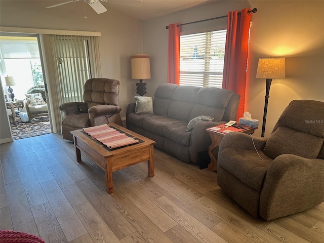 living area featuring light wood-type flooring, ceiling fan, and vaulted ceiling