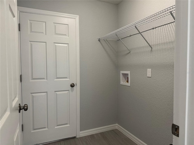 clothes washing area with laundry area, baseboards, dark wood finished floors, a textured wall, and washer hookup