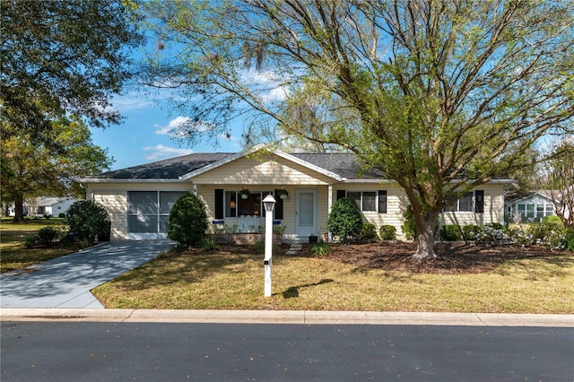 single story home featuring concrete driveway, a front lawn, and a porch