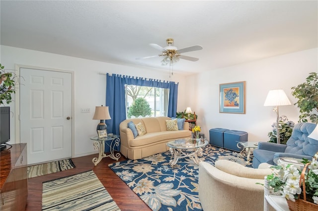 living room featuring a textured ceiling, a ceiling fan, and wood finished floors