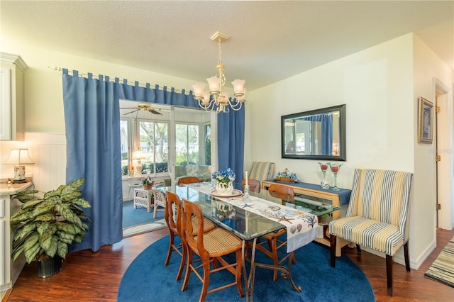 dining room with an inviting chandelier, a textured ceiling, and wood finished floors