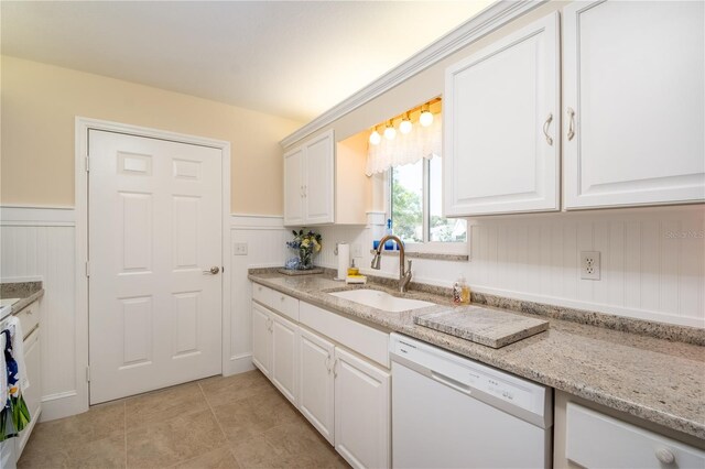 kitchen with a wainscoted wall, white cabinetry, dishwasher, and a sink