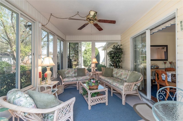 sunroom / solarium featuring a ceiling fan