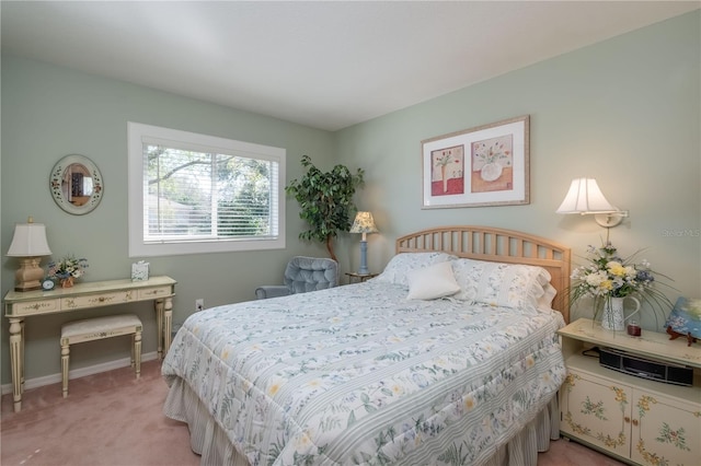 bedroom featuring baseboards and light colored carpet