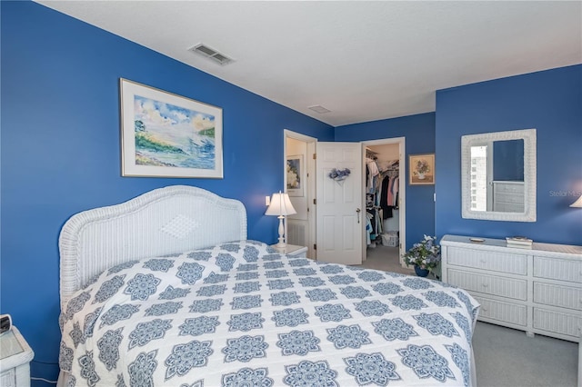 carpeted bedroom with a spacious closet, a closet, and visible vents