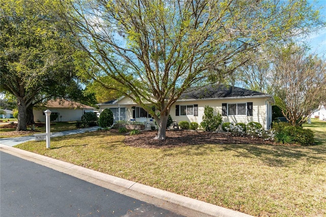 ranch-style home with a front lawn