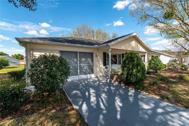 single story home featuring concrete driveway and an attached garage