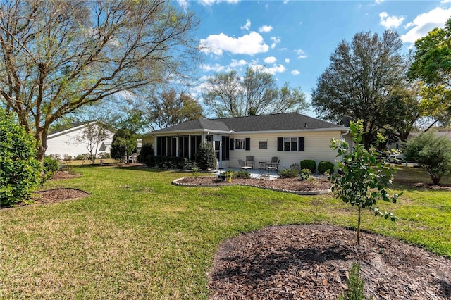 back of house with a lawn, a patio area, and a sunroom