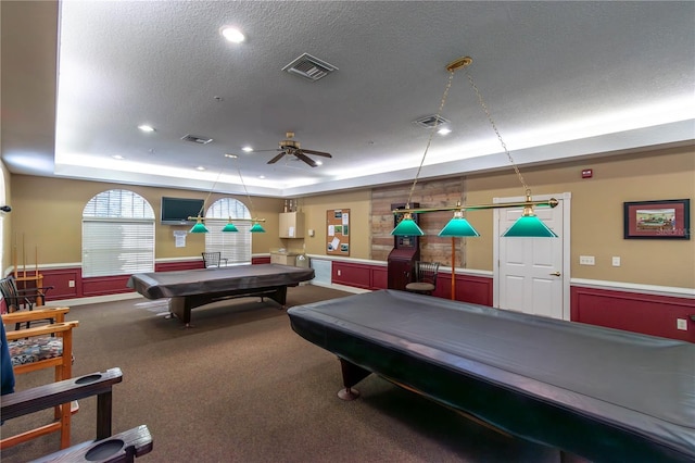 rec room with a raised ceiling, visible vents, billiards, and a textured ceiling