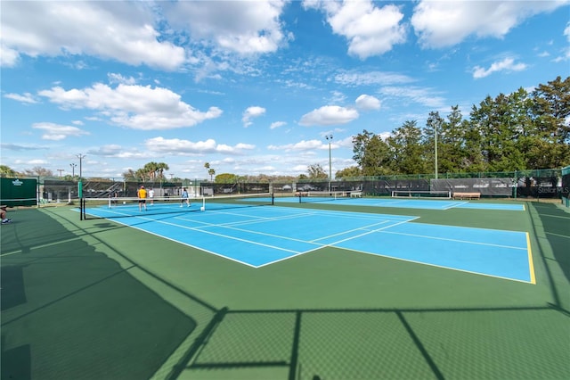 view of sport court featuring fence