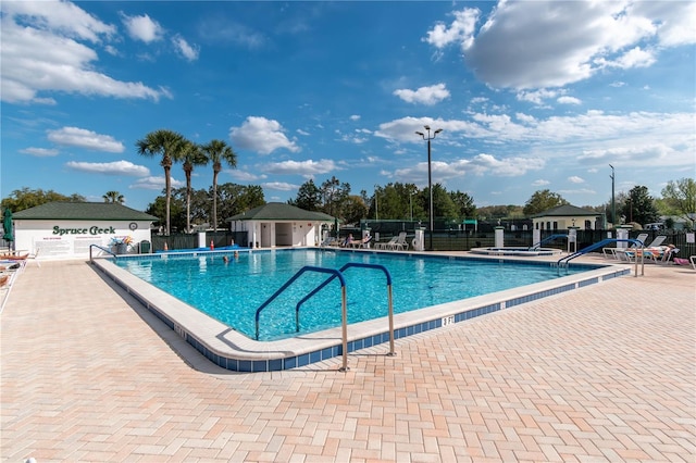 community pool featuring a patio area and fence