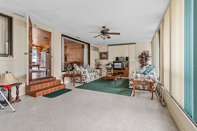 interior space featuring ceiling fan, visible vents, and speckled floor