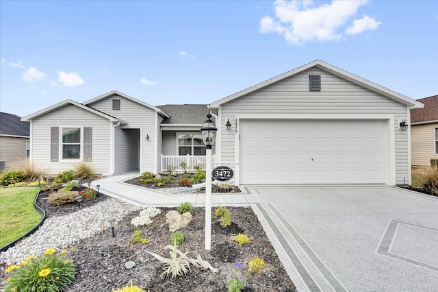 single story home with driveway, an attached garage, and a shingled roof