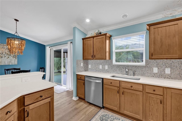 kitchen with backsplash, stainless steel dishwasher, ornamental molding, light wood-style floors, and a sink