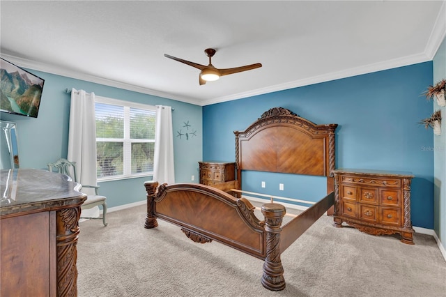 carpeted bedroom featuring ornamental molding, ceiling fan, and baseboards