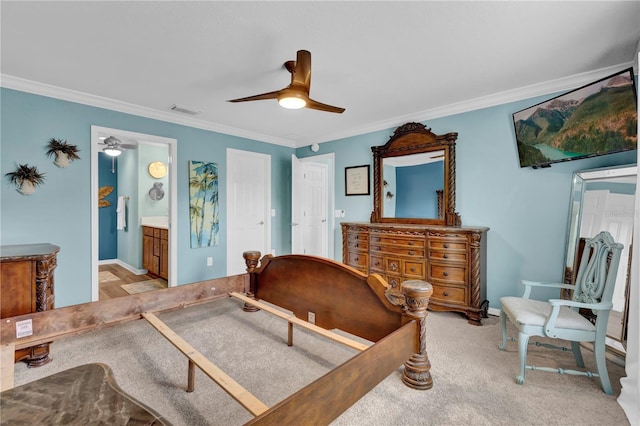 bedroom with visible vents, crown molding, and light colored carpet