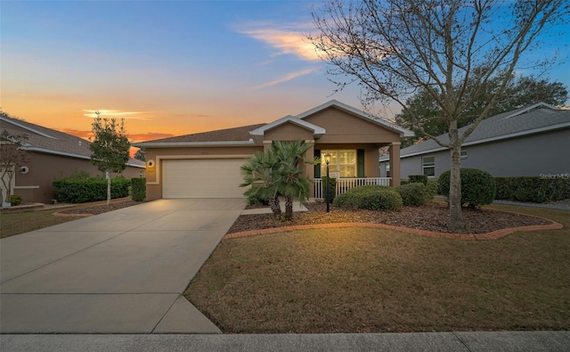 view of front of house with concrete driveway, stucco siding, an attached garage, covered porch, and a front yard