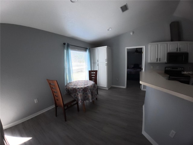 dining room featuring lofted ceiling, visible vents, dark wood finished floors, and baseboards