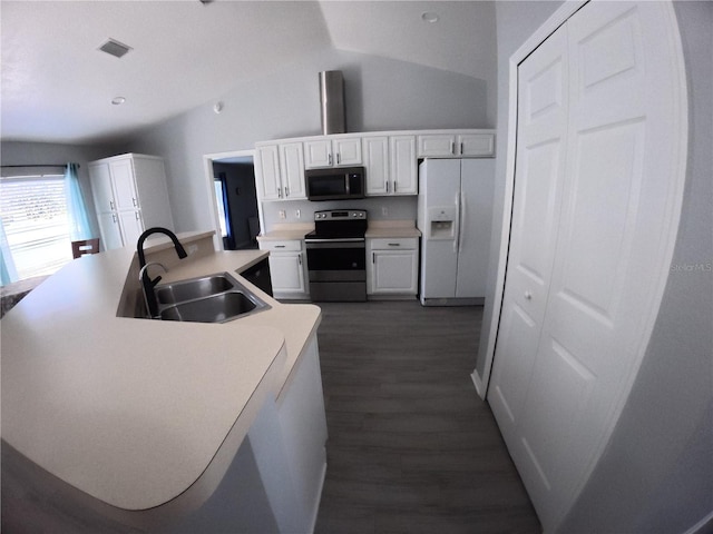 kitchen featuring a sink, visible vents, white cabinets, stainless steel electric range, and white fridge with ice dispenser