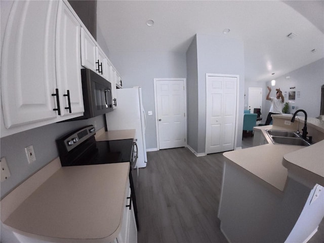 kitchen featuring black microwave, dark wood-style flooring, stainless steel range with electric stovetop, white cabinetry, and a sink