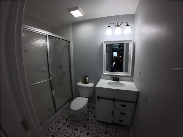 full bathroom featuring toilet, a stall shower, tile patterned flooring, and vanity