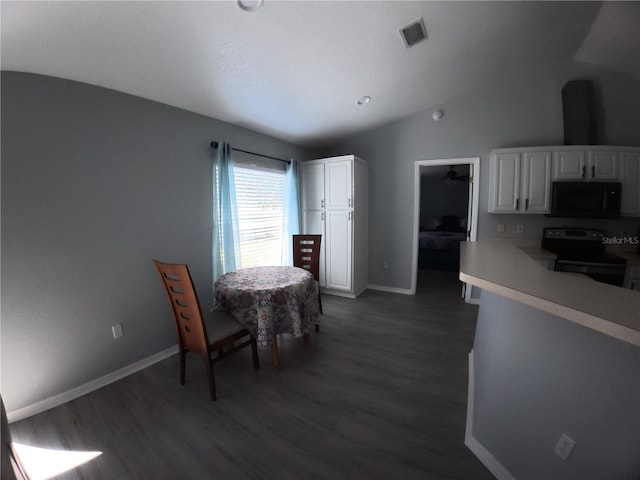 dining room with lofted ceiling, baseboards, visible vents, and dark wood-type flooring