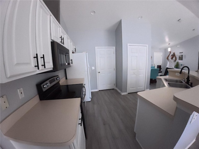 kitchen with black microwave, dark wood-type flooring, a sink, white cabinetry, and electric stove