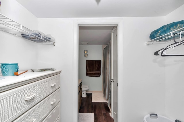 spacious closet with dark wood-type flooring and visible vents