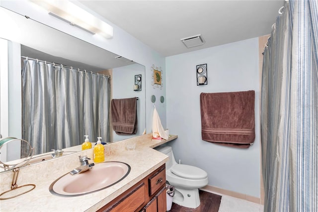 full bathroom featuring visible vents, vanity, and toilet