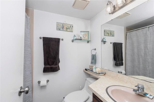 bathroom with visible vents, vanity, and toilet